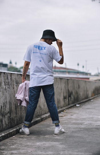 Person Standing Wearing White Shirt and Blue Denim Jeans