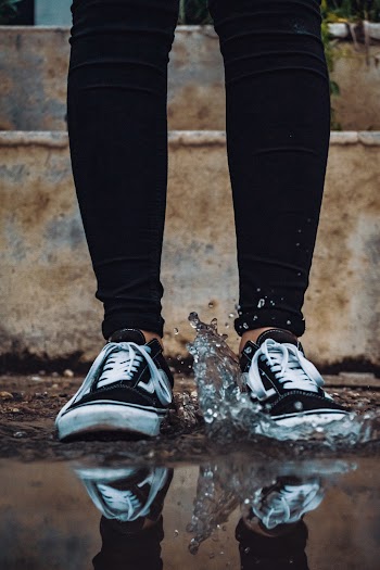 Person Stepping on Body of Water