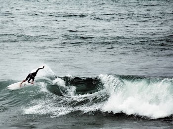 person surfboarding on waves