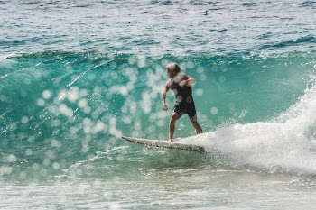Person Surfing on Body of Water