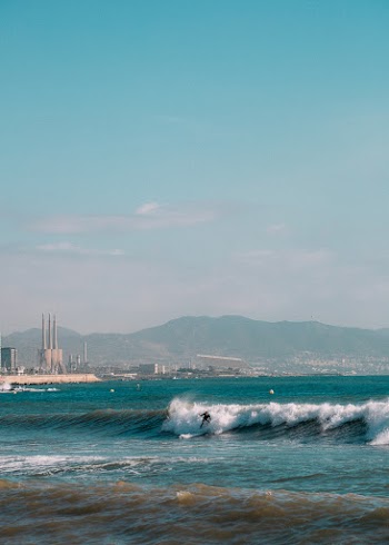 Person Surfing on Sea