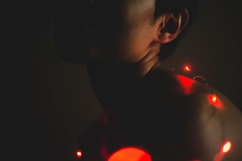 person surrounded their body with lighted string lights