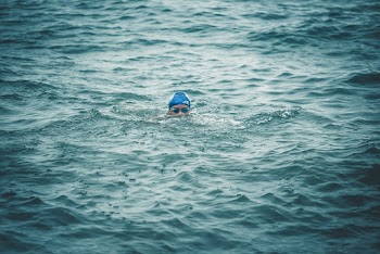 Person Swimming on Sea