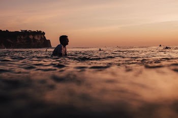 person swimming on sea during daytime