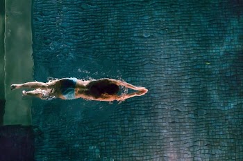person swimming on water