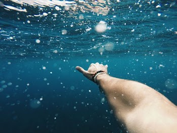 person taking a picture underwater