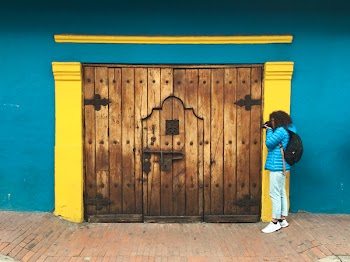 Person Taking Photo of Brown Wooden Door