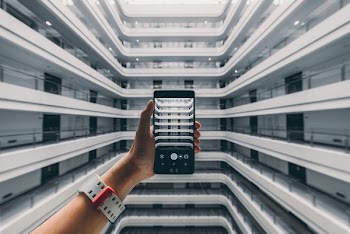 person taking photo of building during daytime