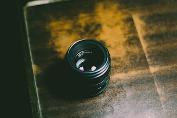 Person Taking Photo of Camera Lens