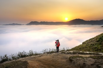 Person  Taking Photo of Clouds