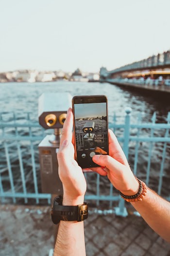 Person Taking Photo of Coin-operated Binoculars