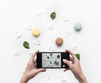 Person Taking Photo of Food and Petals Through Smartphone