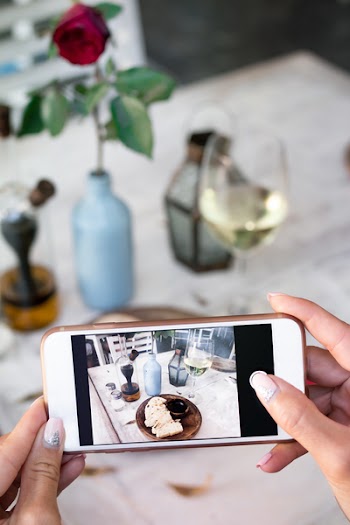 Person Taking Photo of Food in Tray