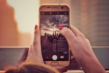 Person Taking Photo of High-rise Buildings