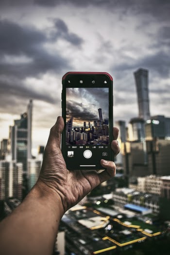 Person Taking Photo Of High Rise Buildings