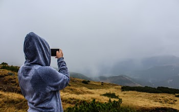 Person Taking Photo of Mountain