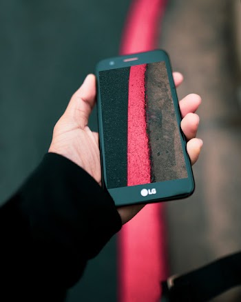 Person Taking Photo of Red Textile