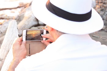 Person Taking Photo of Sunset