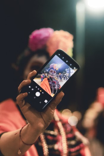 Person Taking Selfie to Black Android Smartphone
