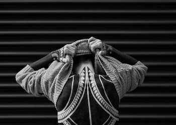 Person Taking Sweater Off in Grayscale Photography