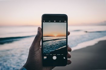 person talking selfie of sea shorre