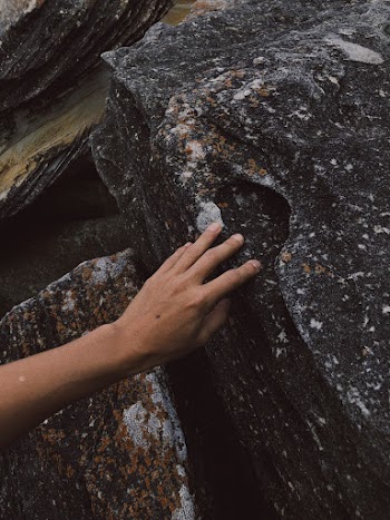 Person Touches the Stone
