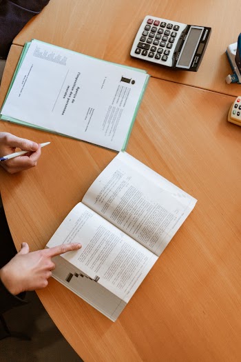 Person Touching Open Book
