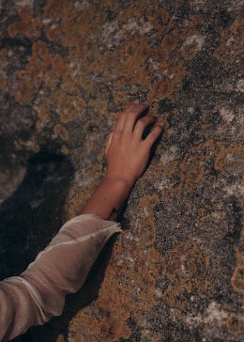 Person Touching Rock