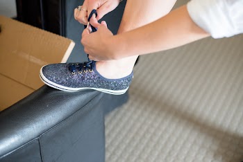 Person Tying Shoelace