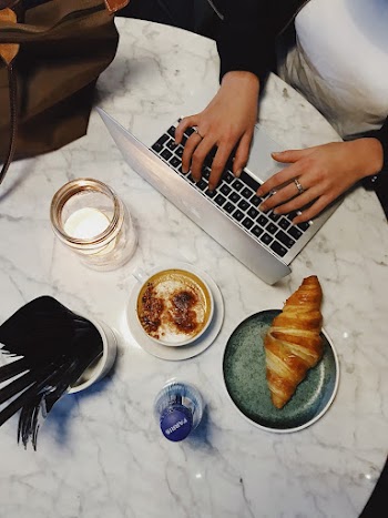 Person Typing On Laptop Keyboard