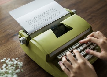 Person Typing on Typewriter
