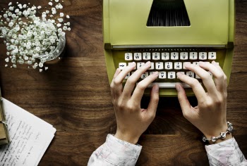 Person Typing On Typewriter