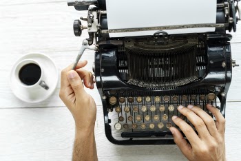 Person Typing Using Typewriter