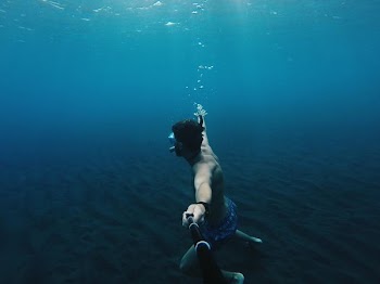 person under body of water