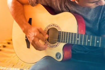 Person Using A Guitar