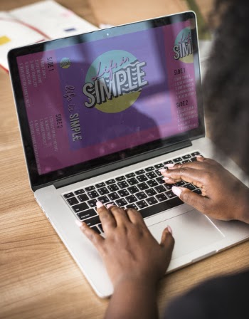 Person Using a Laptop on Table