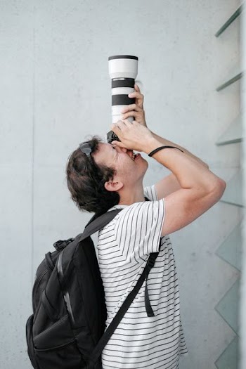 person using black and white DSLR camera