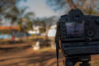 Person Using Black Dslr Camera