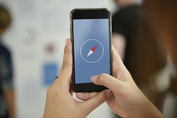 Person Using Compass Iphone Application