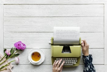 Person Using Green Typewriter