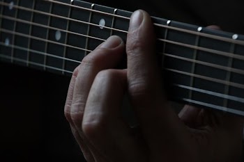 person using guitar