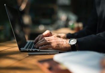 person using laptop on on tabletop