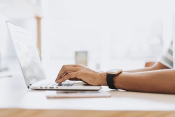 Person Using Laptop On Table