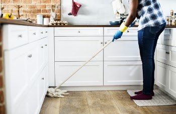 Person Using Mop on Floor