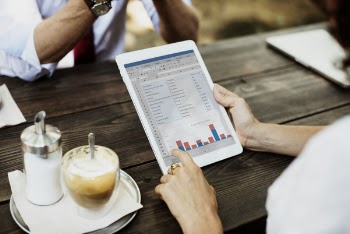 Person Using Silver Ipad on Chart