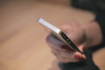 Person Using Silver Iphone 5s