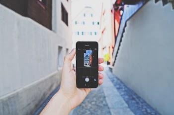 Person Using Space Gray Iphone 5s Taking a Picture of Building during Day