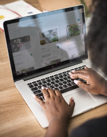 Person Using Turned on Macbook Pro