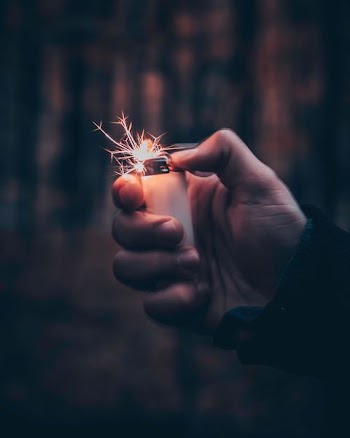 person using white disposable lighter