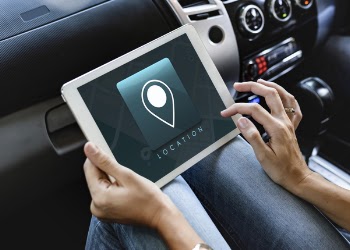 Person Using White Tablet Computer Displaying Location Text